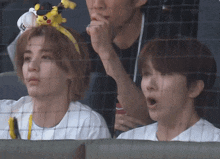 a man wearing a pikachu headband looks surprised
