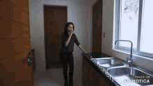 a woman talking on a cell phone in a kitchen that was made in animotica