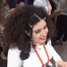 a woman with a lanyard around her neck that says ' i 'm a girl ' on it