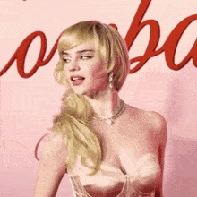 a woman in a corset is standing in front of a sign that says ' a ' on it