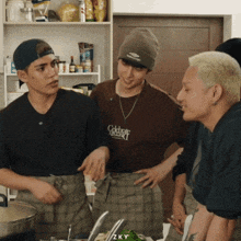 a man wearing a brown shirt that says college cooking talks to another man