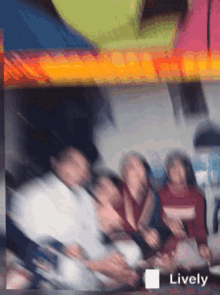 a blurry picture of a group of people with the word lively on the bottom right
