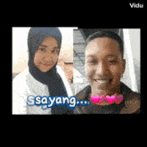 a man and a woman are standing next to each other and the words sayang are on the bottom
