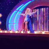 two drag queens on a stage with their arms out