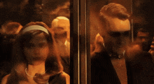 a man and a woman looking out a window