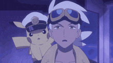 a man and a pikachu wearing a hat with the letter e on it