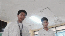 two boys are posing for a picture and one has a lanyard around his neck that says ' philippines ' on it