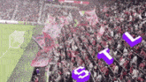 a crowd of people in a stadium with the letters s and t floating in the air
