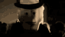 a cartoon character is wearing a top hat and pointing at the camera in a black and white photo .