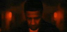a close up of a man 's face with red and blue lights in the background