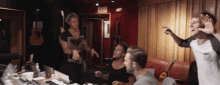 a group of men in a room with an exit sign