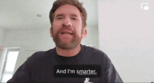 a man with a beard is wearing a shirt that says and i 'm smarter