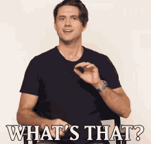 a man in a black shirt says " what 's that " in white letters