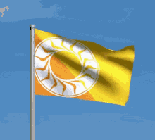 a yellow and orange flag with a white circle on it