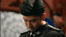 a close up of a man 's face with an ioiyi logo on the bottom right