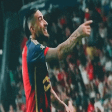 a soccer player wearing a red and blue jersey with the number 21 on it