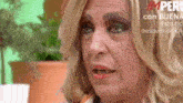 a close up of a woman 's face with a sign that says imperio on it
