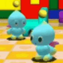 two blue stuffed animals are standing next to each other on a yellow tile floor .