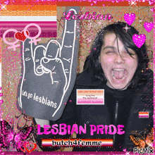 a picture of a woman holding a foam hand that says lesbians