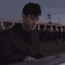 a man playing a keyboard in front of a crowd of people