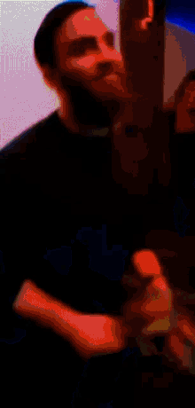 a blurry picture of a man with a beard in a blue room
