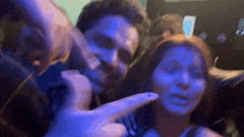 a blurry photo of a man and a woman in a dark room