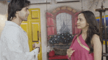a man and a woman are standing next to each other
