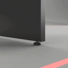a gray floor with a red line on it