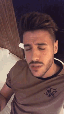 a man with a beard is wearing a siksilk t-shirt