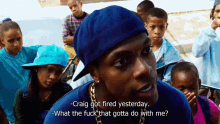 a man in a blue hat is talking to a group of children and says " craig got fired yesterday "