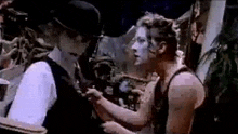 a man and a woman are standing next to each other .