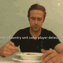 a man is sitting at a table with a bowl of soup and the words ho14 country unit color player detected above him