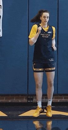 a female basketball player wearing a jersey that says indiana fever