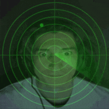 a man wearing headphones is being monitored by a green radar screen