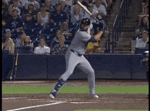 a baseball player swings his bat at a pitch