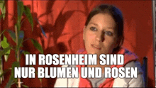 a woman is sitting in front of a plant with the words in rosenheim sind nur blumen und rosen written below her