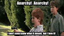 a boy holding a gun with the words anarchy written above him