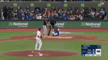a baseball game is being played in front of a national car rental advertisement