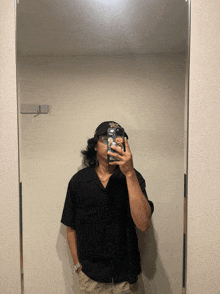 a man taking a selfie in front of a mirror