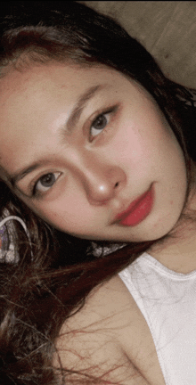 a close up of a woman 's face with red lipstick
