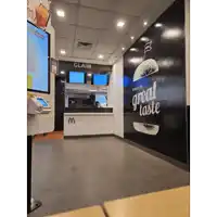a mcdonald 's restaurant with a sign that says " claim "