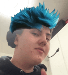 a man with a blue mohawk on his head
