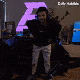 a man in a nasa sweatshirt is dancing in front of a tv