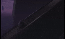 a person is walking down a set of stairs in a dark room .