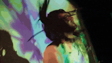 a blurry picture of a man with dreadlocks dancing