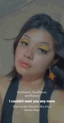 a close up of a woman 's face with yellow eyeshadow