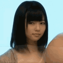 a close up of a woman 's face with a blurry background