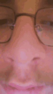 a man with glasses and a beard is smiling