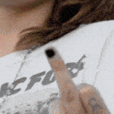 a close up of a person 's middle finger with the word fuck written on it