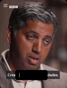 a close up of a man 's face with bbc on the bottom right